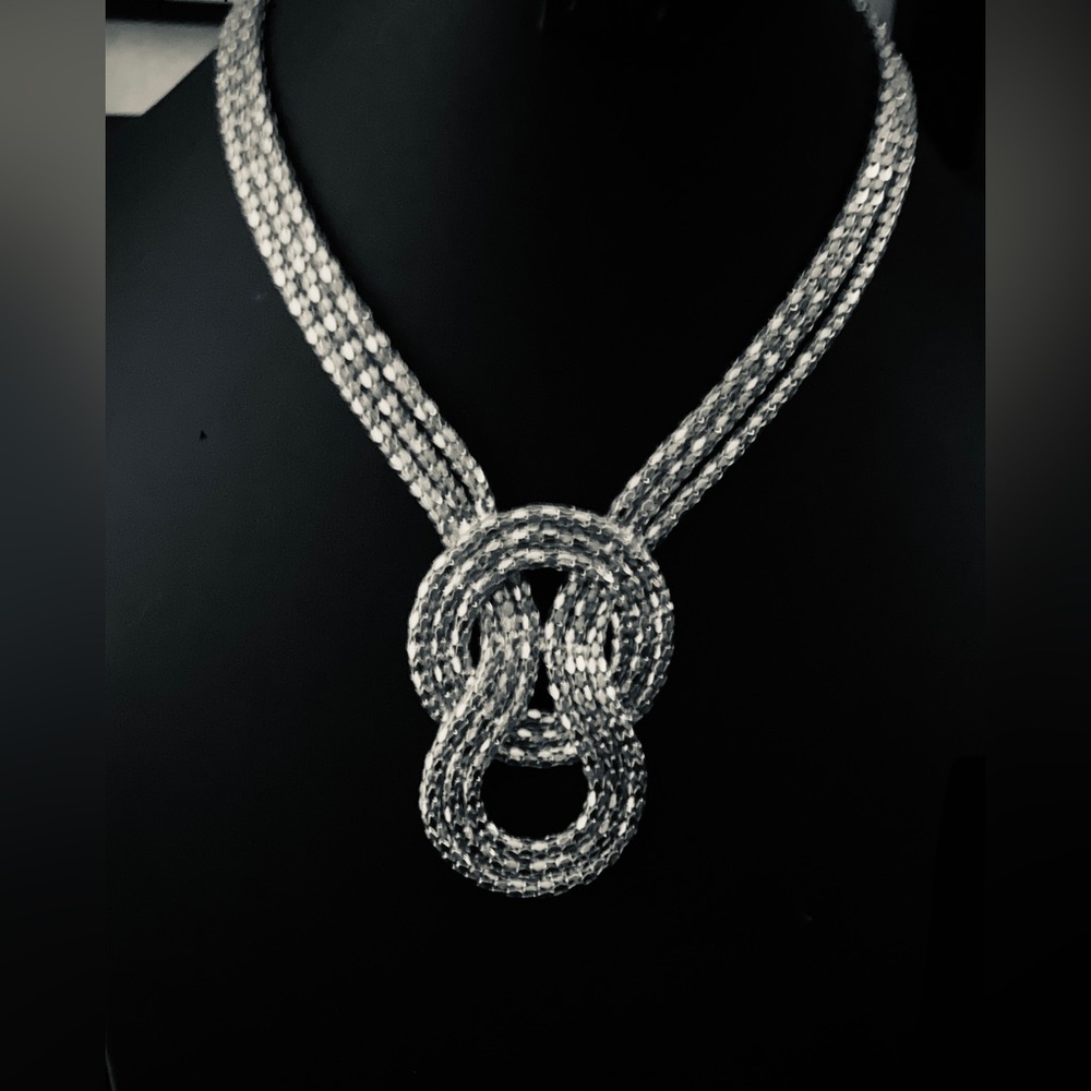 Silver tone, multi strand knot necklace.